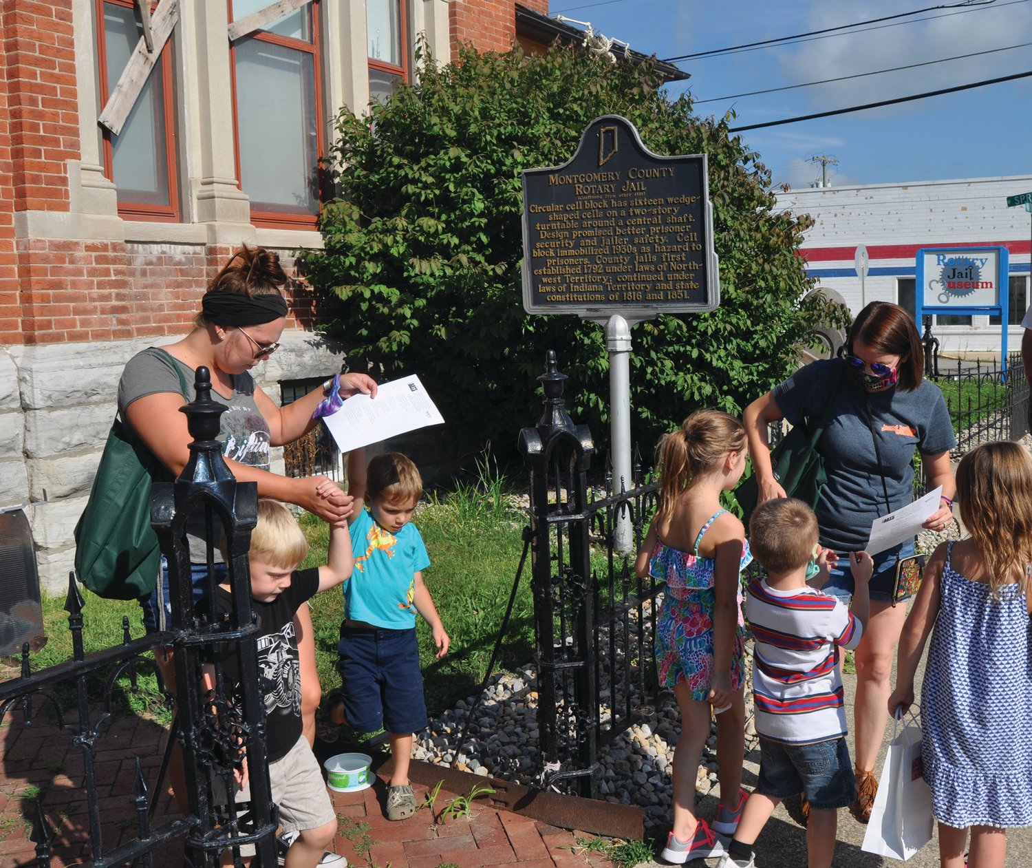Chelsea Emberton, left, and Amber Wheeldon reach the Rotary Jail Museum with Kartyr, Kreed, Boston, Colt and Charlie during Athens Arts Gallery's Art Quest on Saturday in downtown Crawfordsville. Families followed riddle-like clues to collect prizes at downtown cultural attractions.